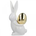 Floristik24 Påskeharer elegante, keramiske kaniner med guldæg, påskedekoration hvid, gylden H18cm 2 stk.